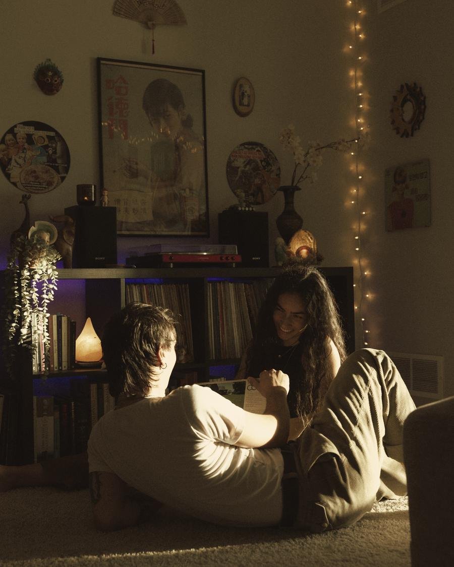 Jordan and his fiancée at home, listening to records by lamplight
