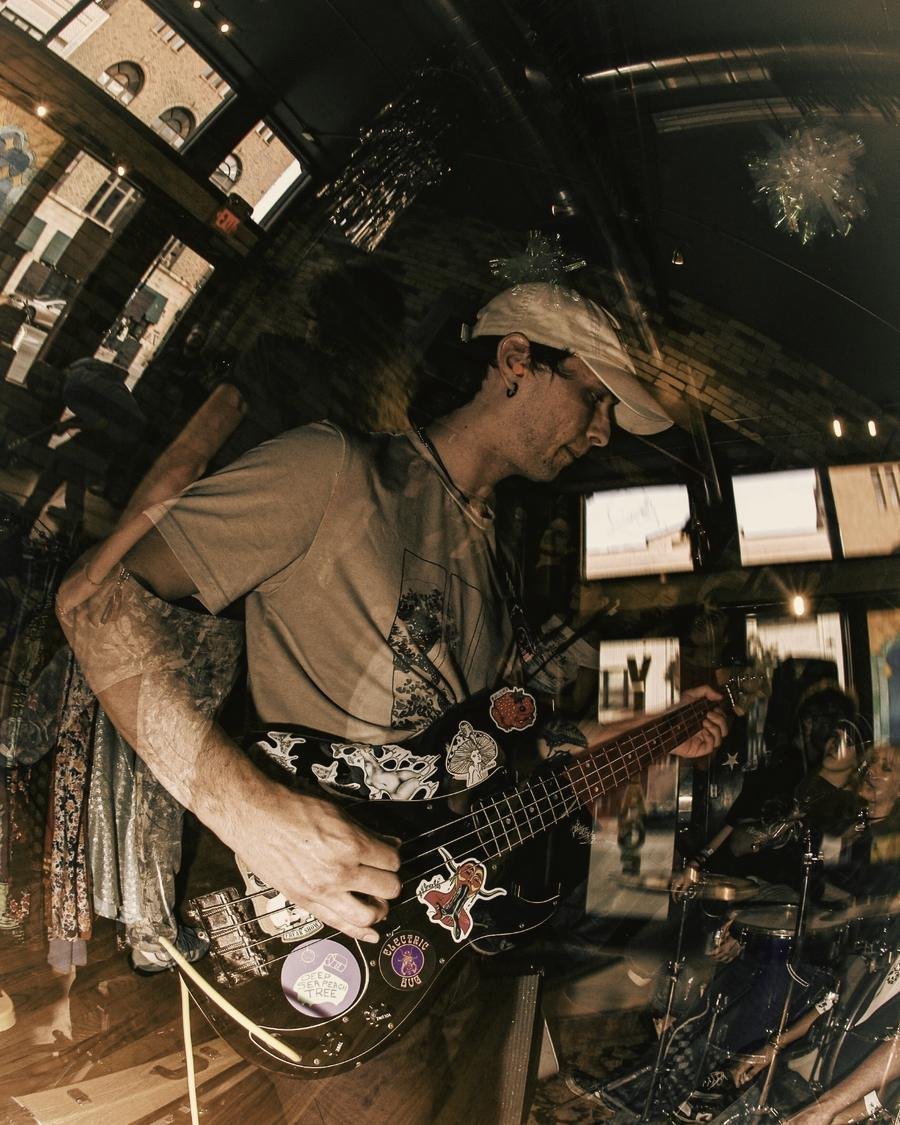 Jordan playing bass guitar at a live show